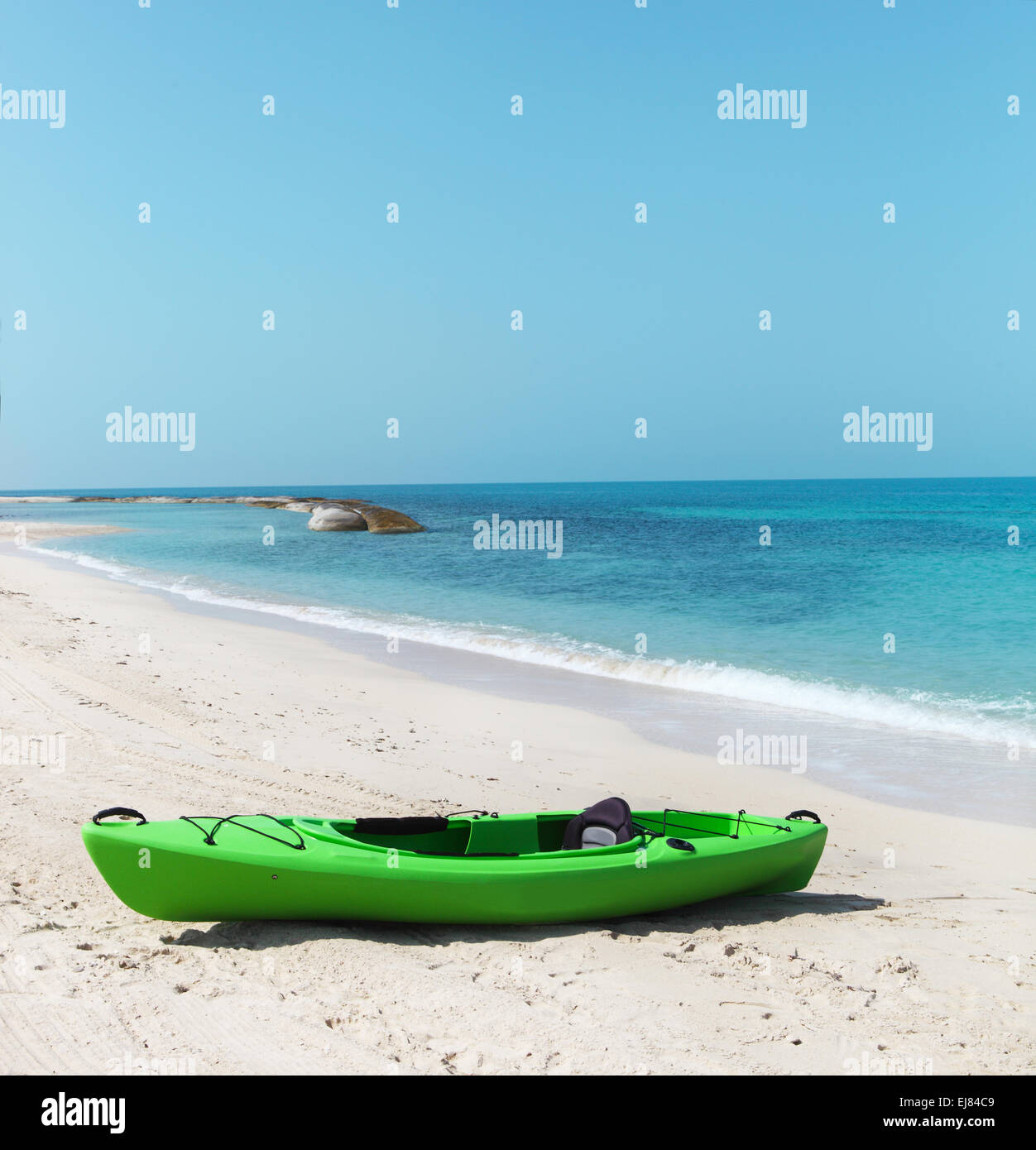 Green kayak on the beach Stock Photo - Alamy