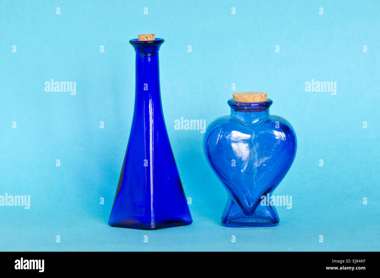 two beautiful blue decorative glass bottle on azure background Stock Photo Alamy