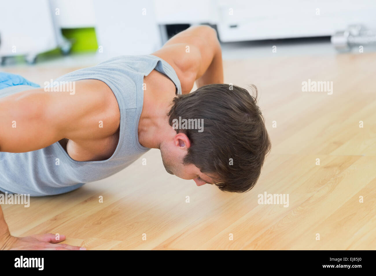 Determined man doing push ups in gym Stock Photo - Alamy