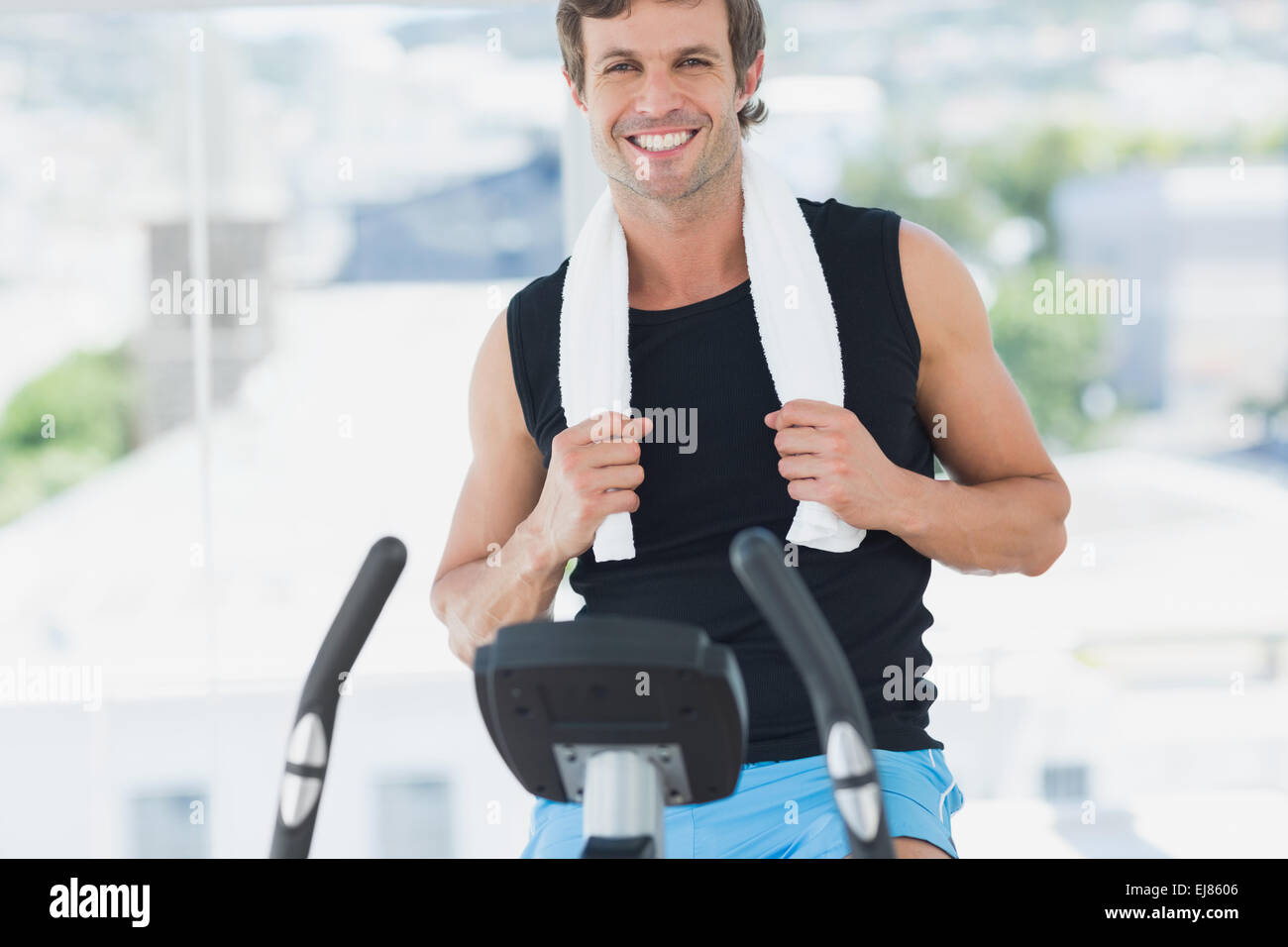 Smiling man working out at spinning class in bright gym Stock Photo - Alamy