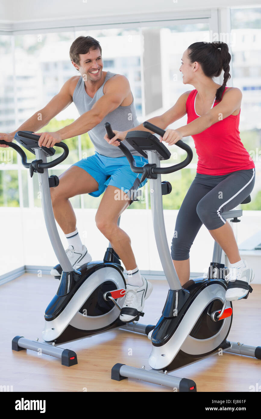 Smiling young couple working out at spinning class Stock Photo - Alamy