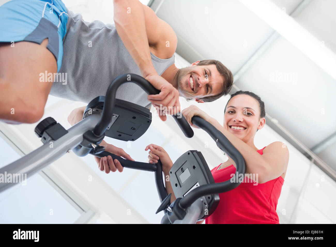 Smiling young couple working out at spinning class Stock Photo - Alamy