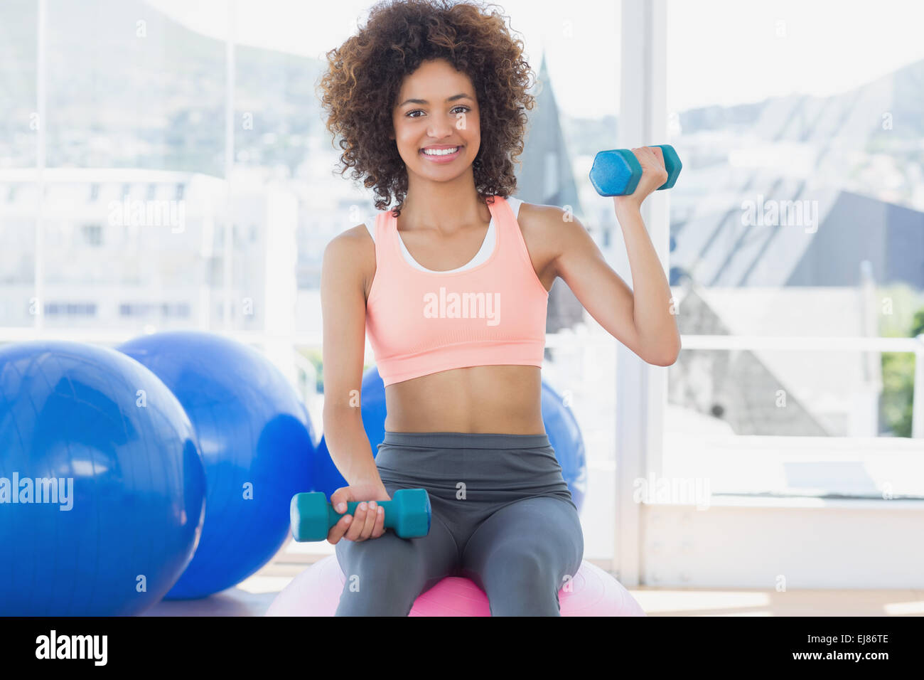 Woman wearing sports bra exercising with a kettle bell Stock Photo - Alamy