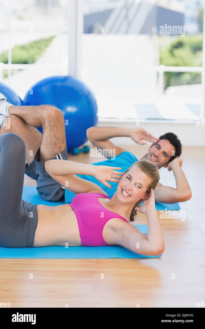 Portrait of a young couple exercising at gym Stock Photo - Alamy