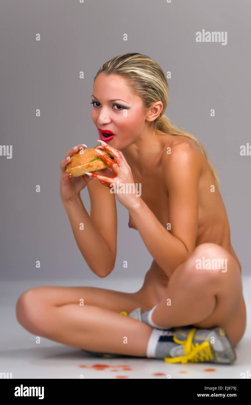 naked woman eating a hamburger Stock Photo - Alamy