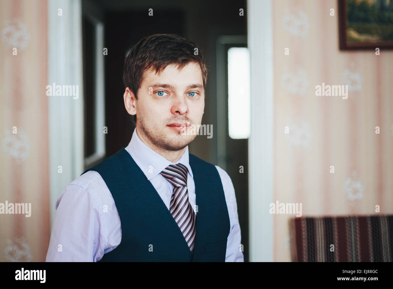 Handsome Caucasian Man In Business Attire Staying In Room Stock Photo