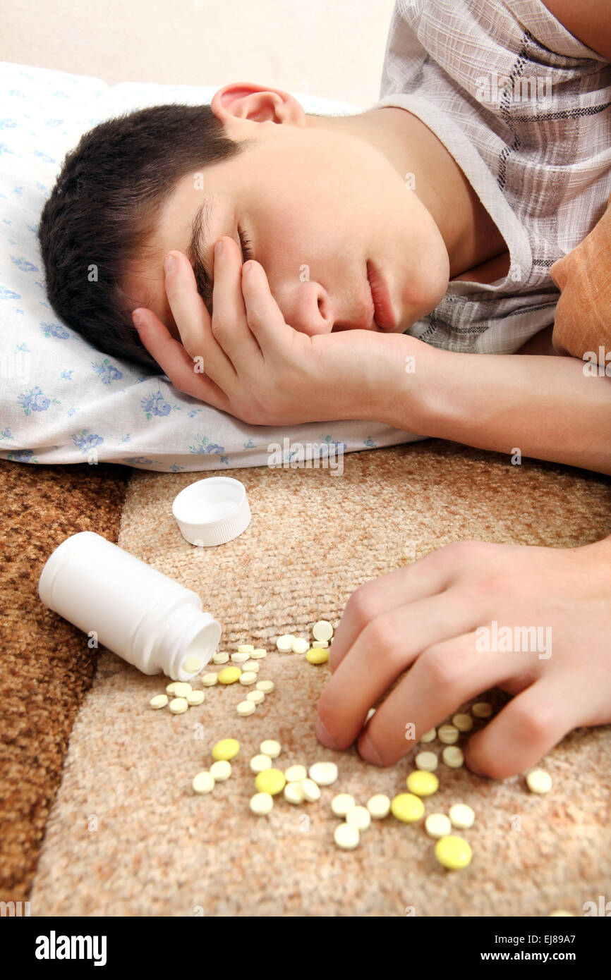 Teenager sleeps near the Pills Stock Photo