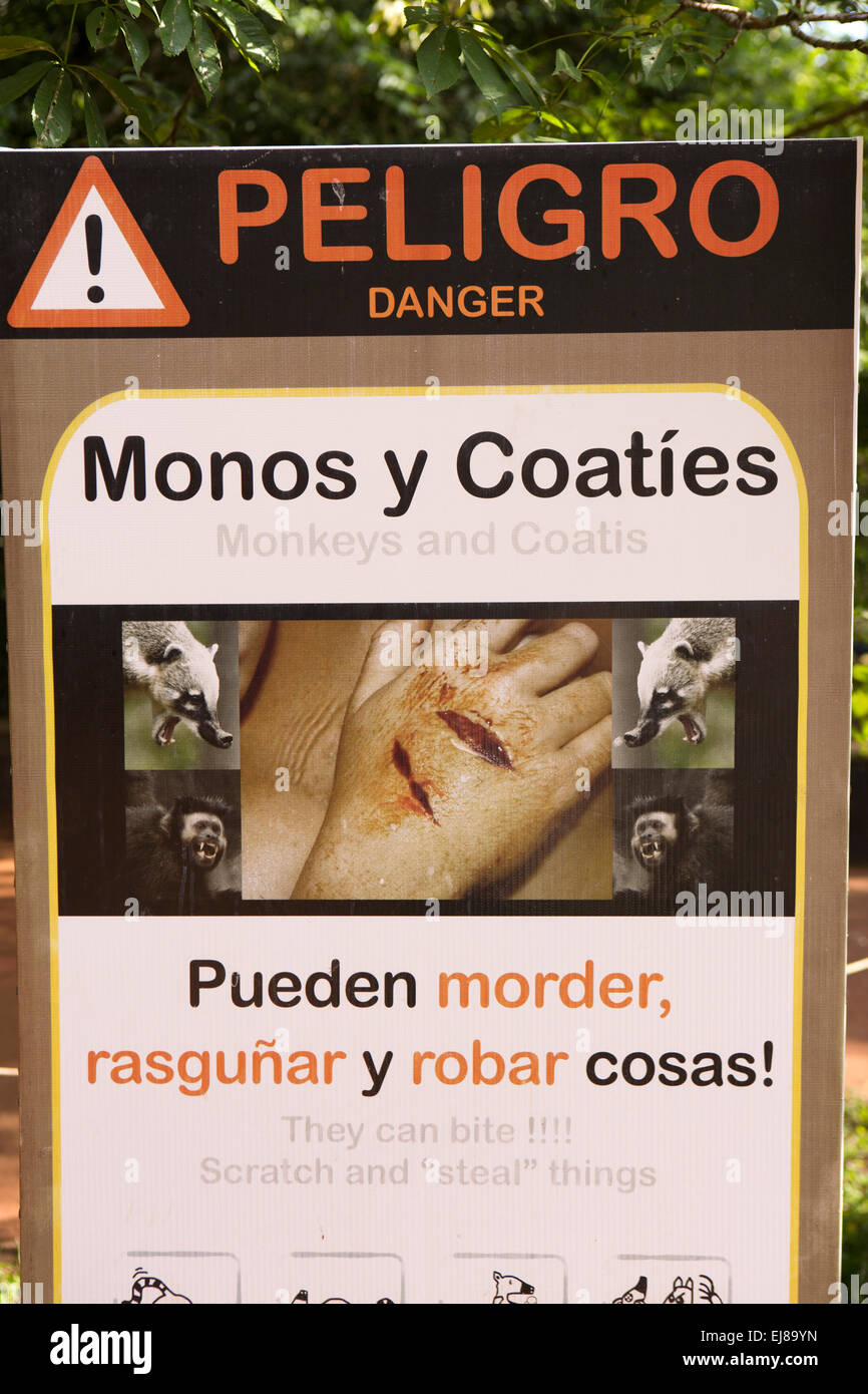 Argentina, Iguazu, Falls National Park, monkeys and coatis danger warning sign Stock Photo