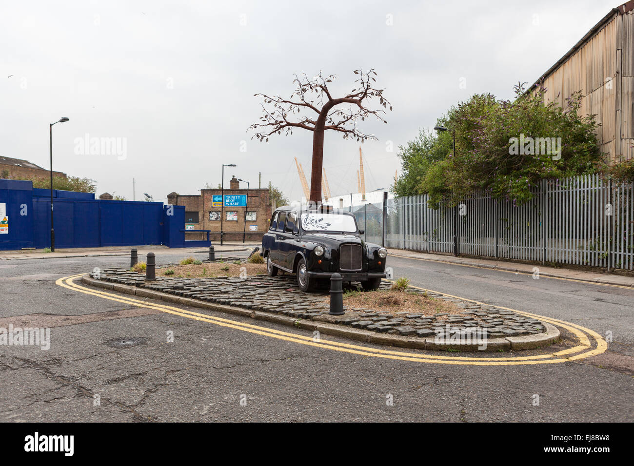 London Taxi with tree growing out the top at Trinity Buoy Wharf Stock Photo