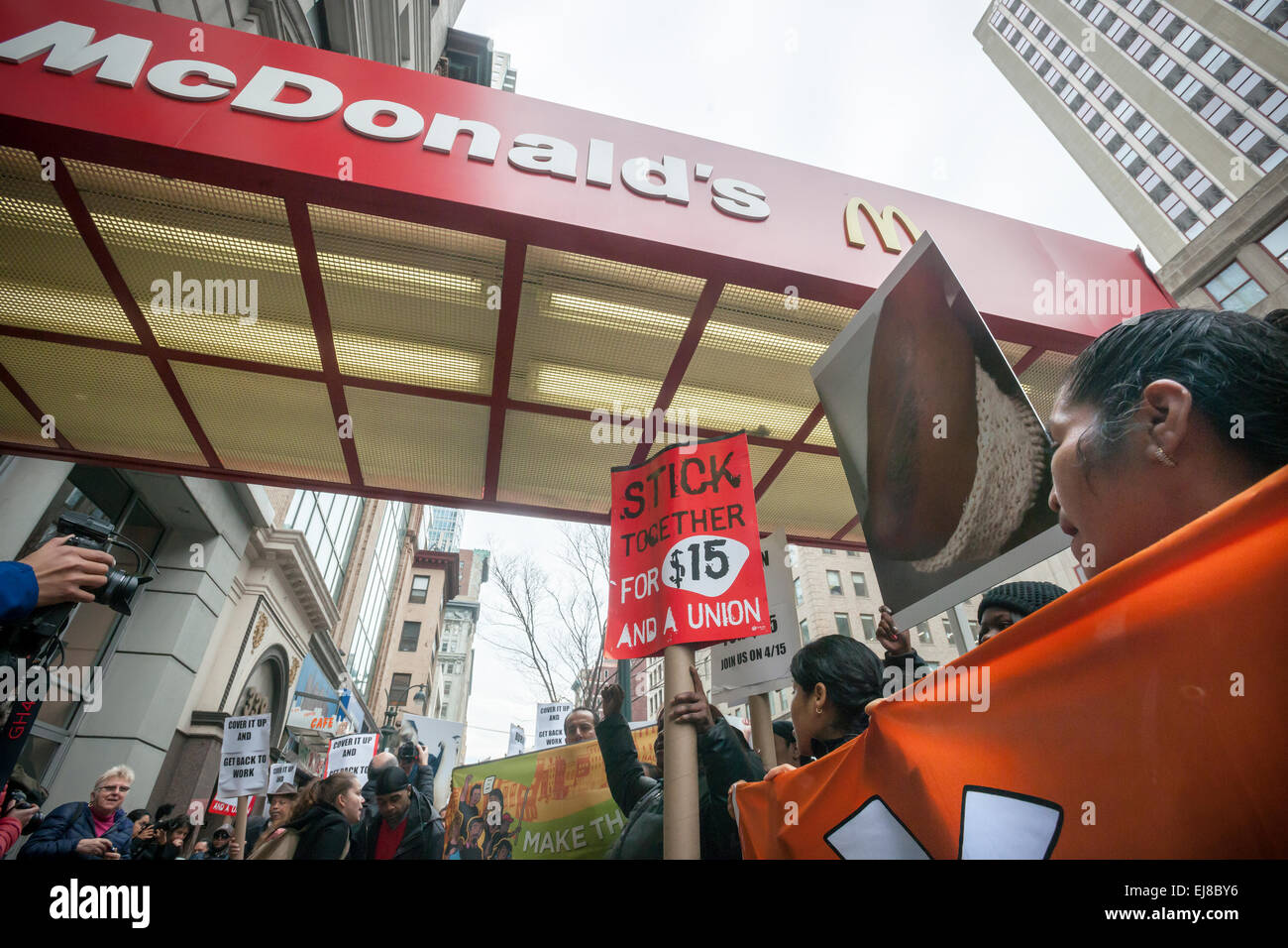 Workers at fast food restaurants and their supporters protest in front