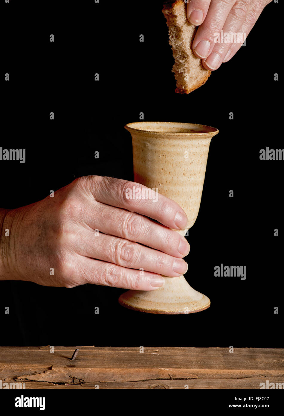 chalice of wine and bread on the dark background Stock Photo