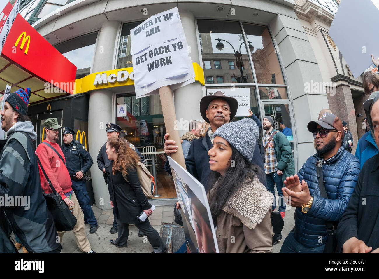 Workers at fast food restaurants and their supporters protest in front of a McDonald's restaurant in New York on Tuesday, March 17, 2015. Fast food workers have filed 28 OSHA complaints in 19 cities against the fast food chain. The workers allege that understaffing and the pressure to work fast creates hazardous working conditions leading to burns, cuts and other injuries.  (© Richard B. Levine) Stock Photo