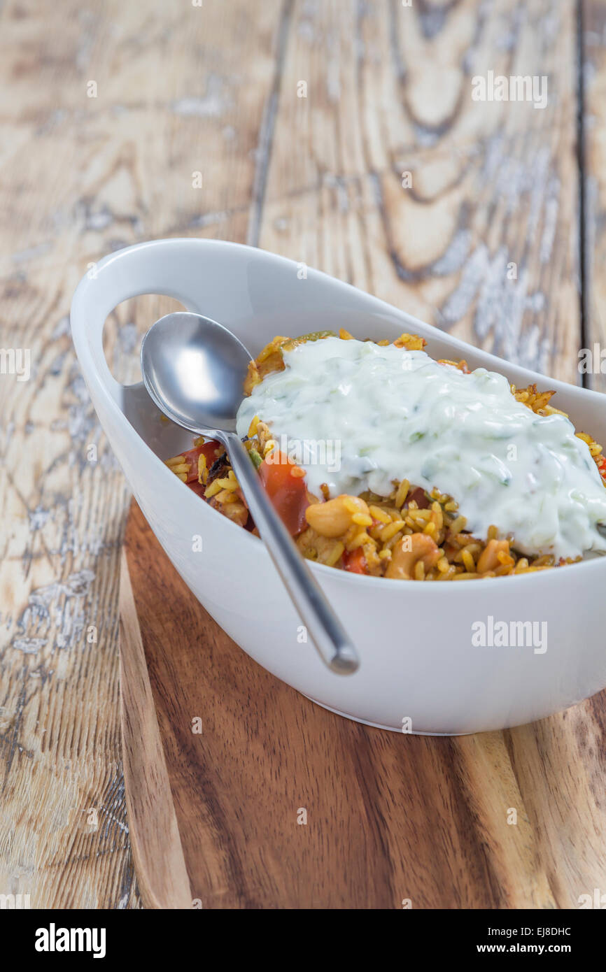 Bowl With Curry Flavored Rice Chicken And Vegetables With Garlic