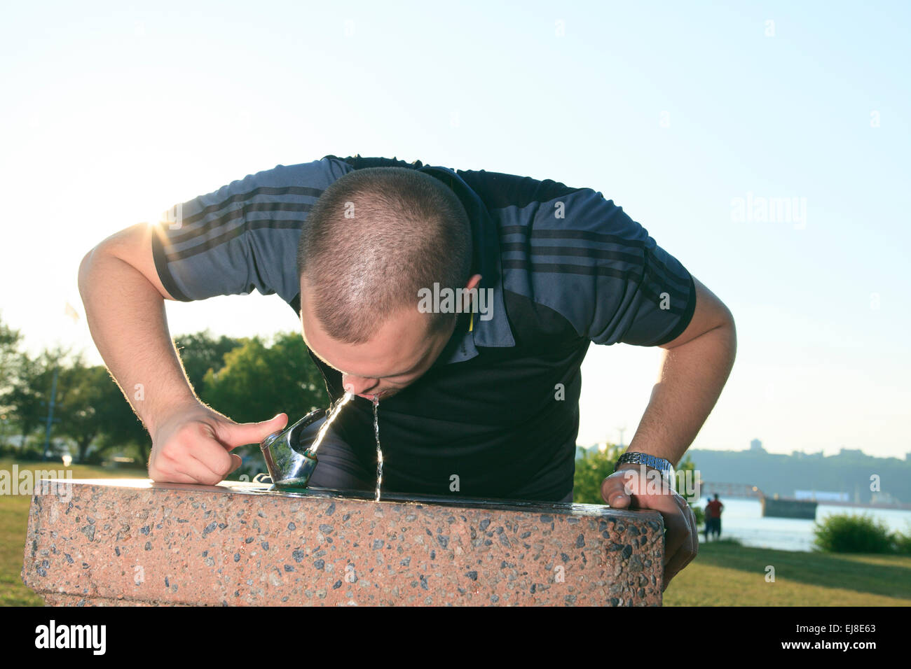 Funny child with a big water bottle Stock Photo by ©Gelpi 9436178