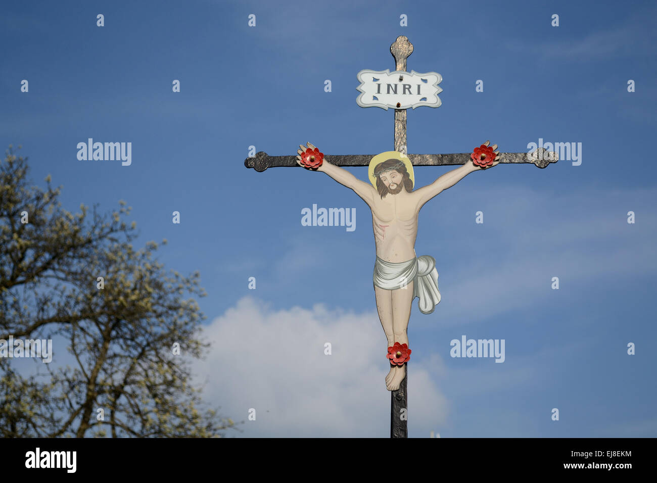 Metal cross with Christ figure Stock Photo