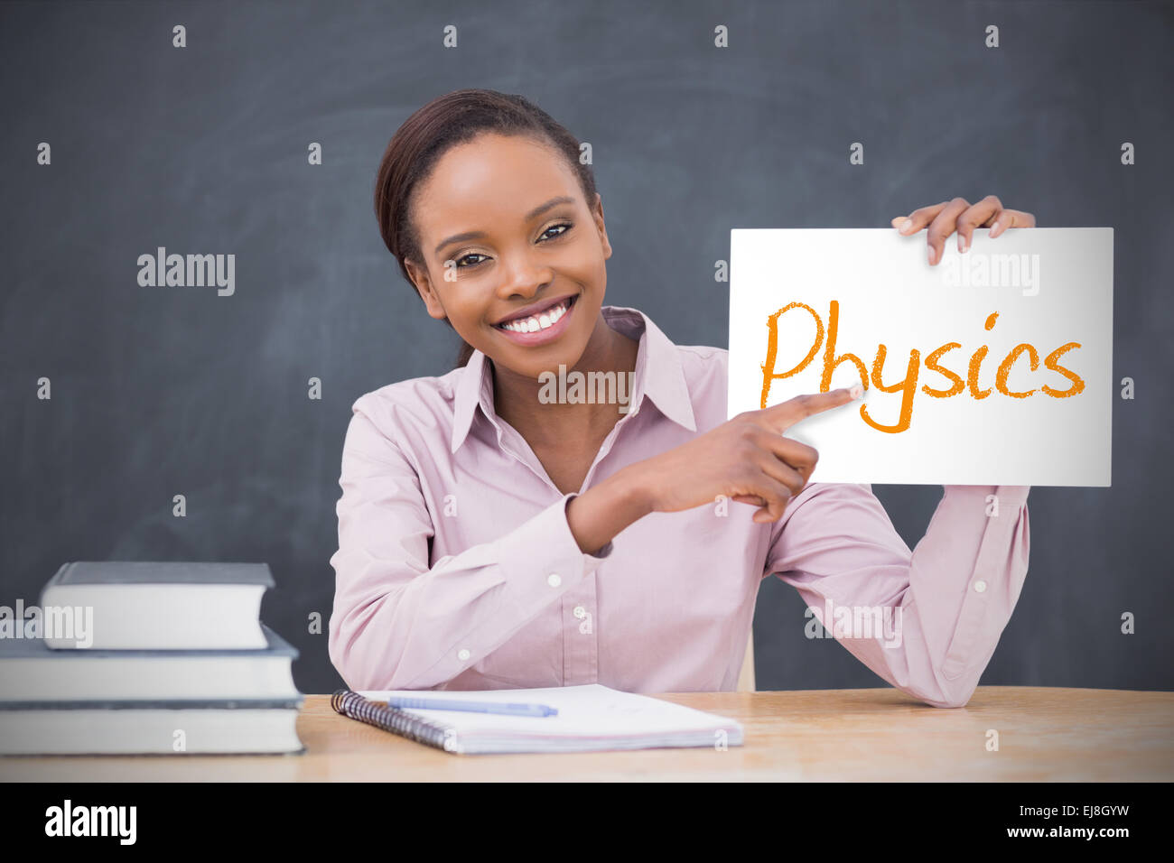 happy-teacher-holding-page-showing-physi