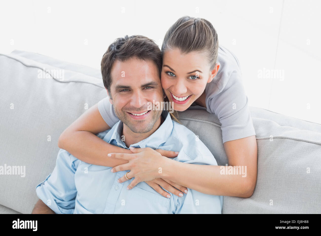 Happy couple smiling up at camera Stock Photo - Alamy