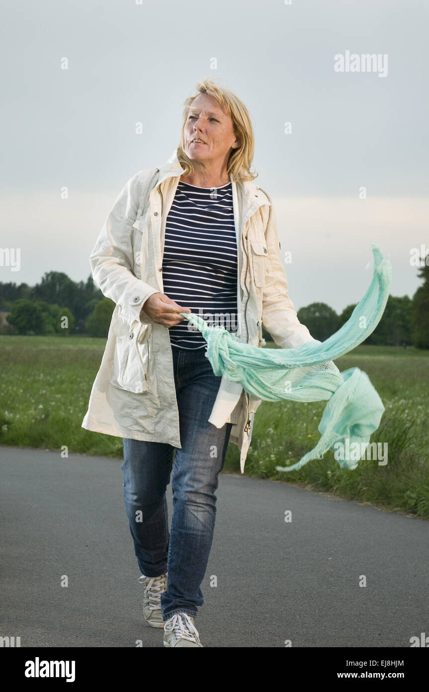 walk on a footpath with scarf Stock Photo