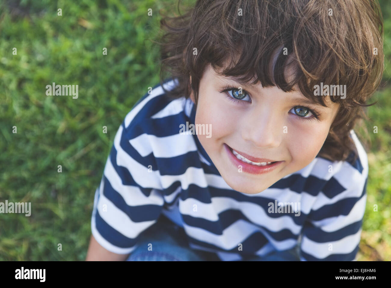 Close-up of a cute boy smiling at park Stock Photo - Alamy