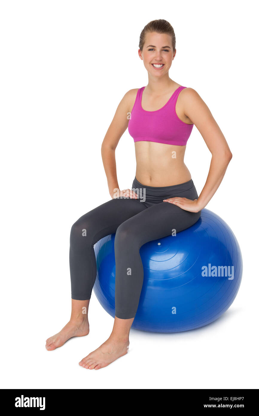 Portrait of a fit woman sitting on exercise ball Stock Photo - Alamy