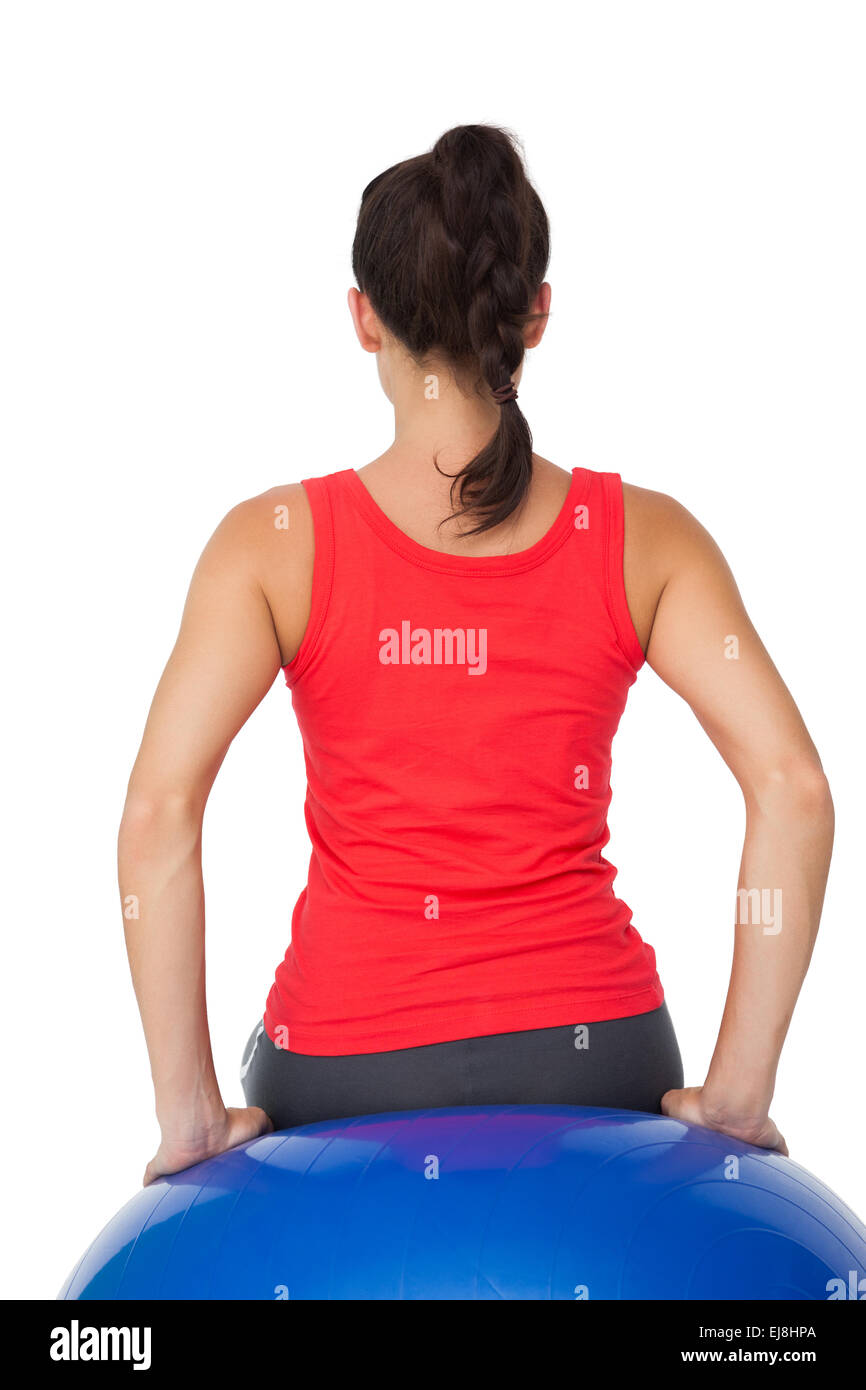 Rear view of a fit woman sitting on exercise ball Stock Photo Alamy
