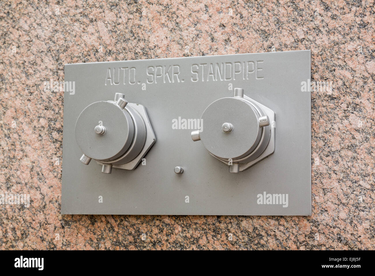 Auto Sprinkler standpipe on marble wall Stock Photo