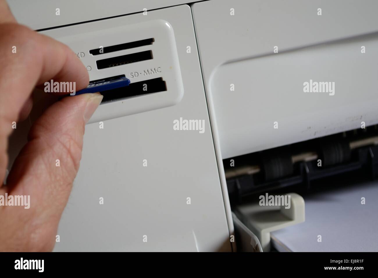 Person inserts the SD card into card reader Stock Photo
