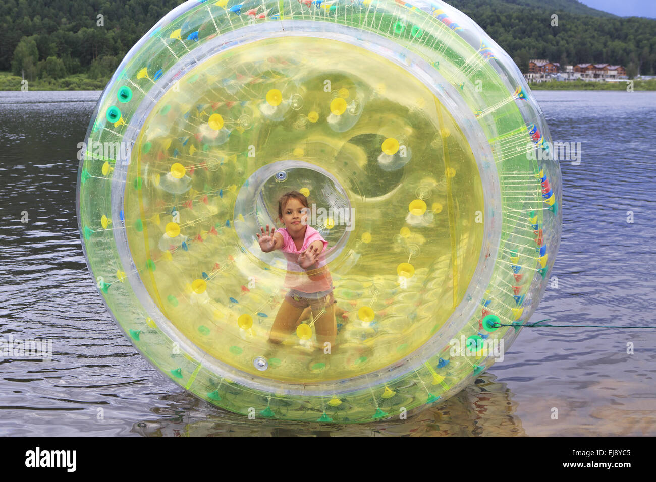 Child in inflatable attraction on the lake. Stock Photo