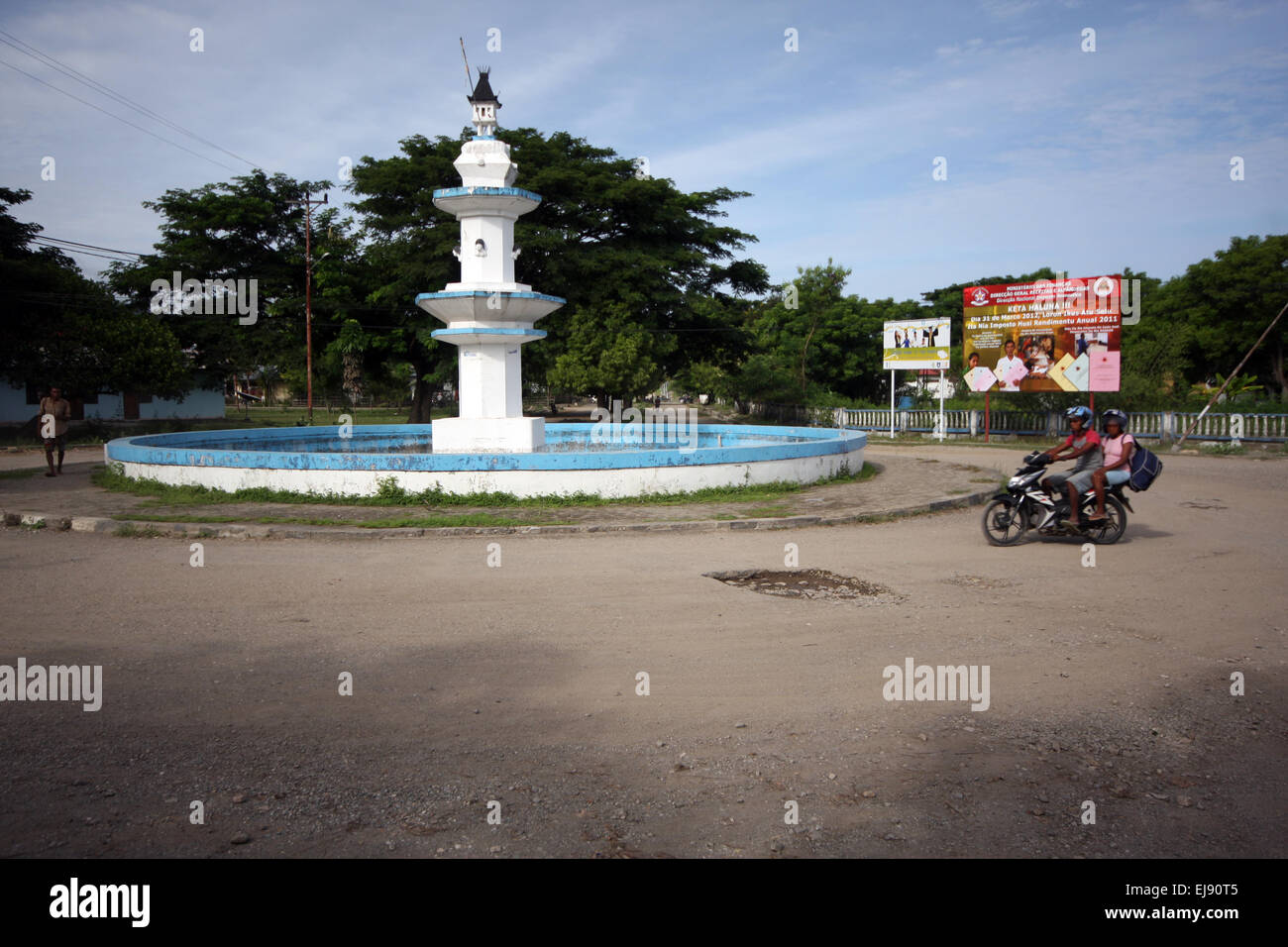 Motorbike going around a roundabout in the centre of Pante Macassar