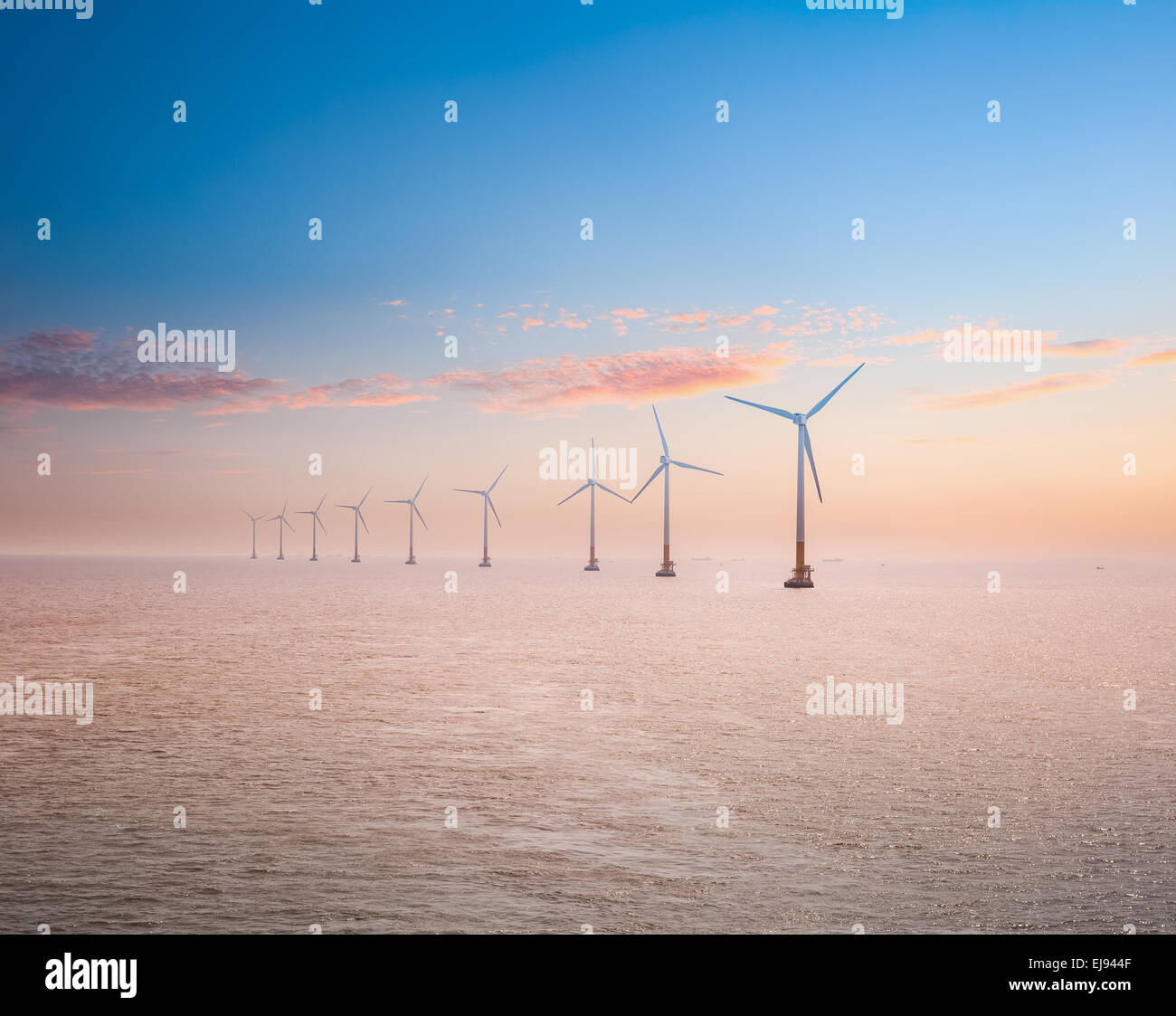 offshore wind power plants in sunset Stock Photo