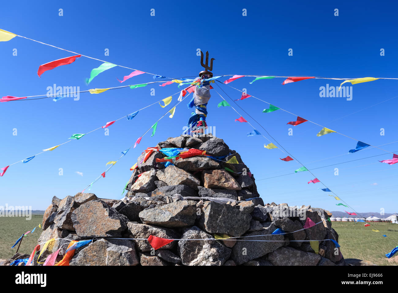 praying stone and prayer flags Stock Photo
