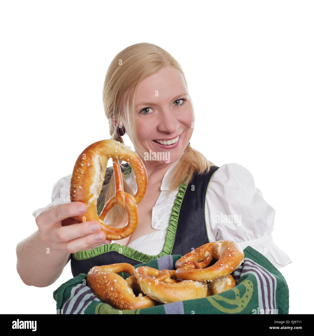Bavarian woman offers a brezel Stock Photo