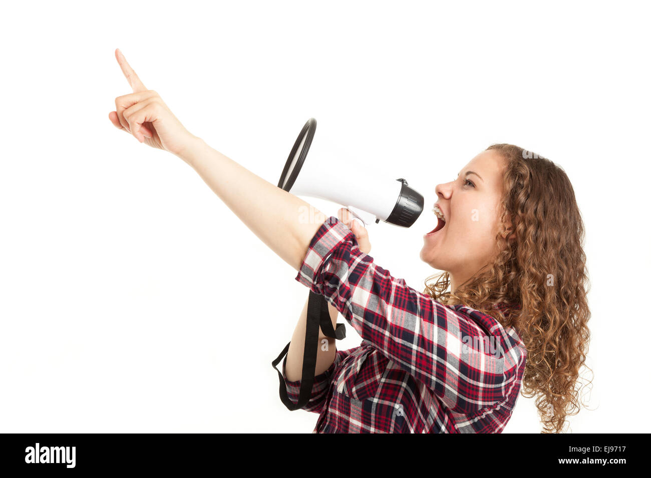 Young woman shouting through a megaphone Stock Photo