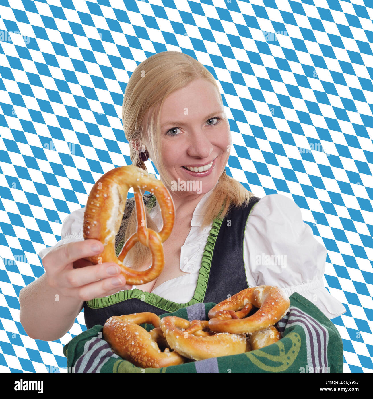 Bavarian woman offering a brezel Stock Photo