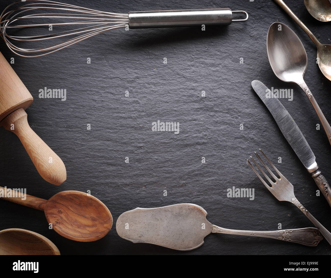 Cooking utensils on a dark gray background. Stock Photo