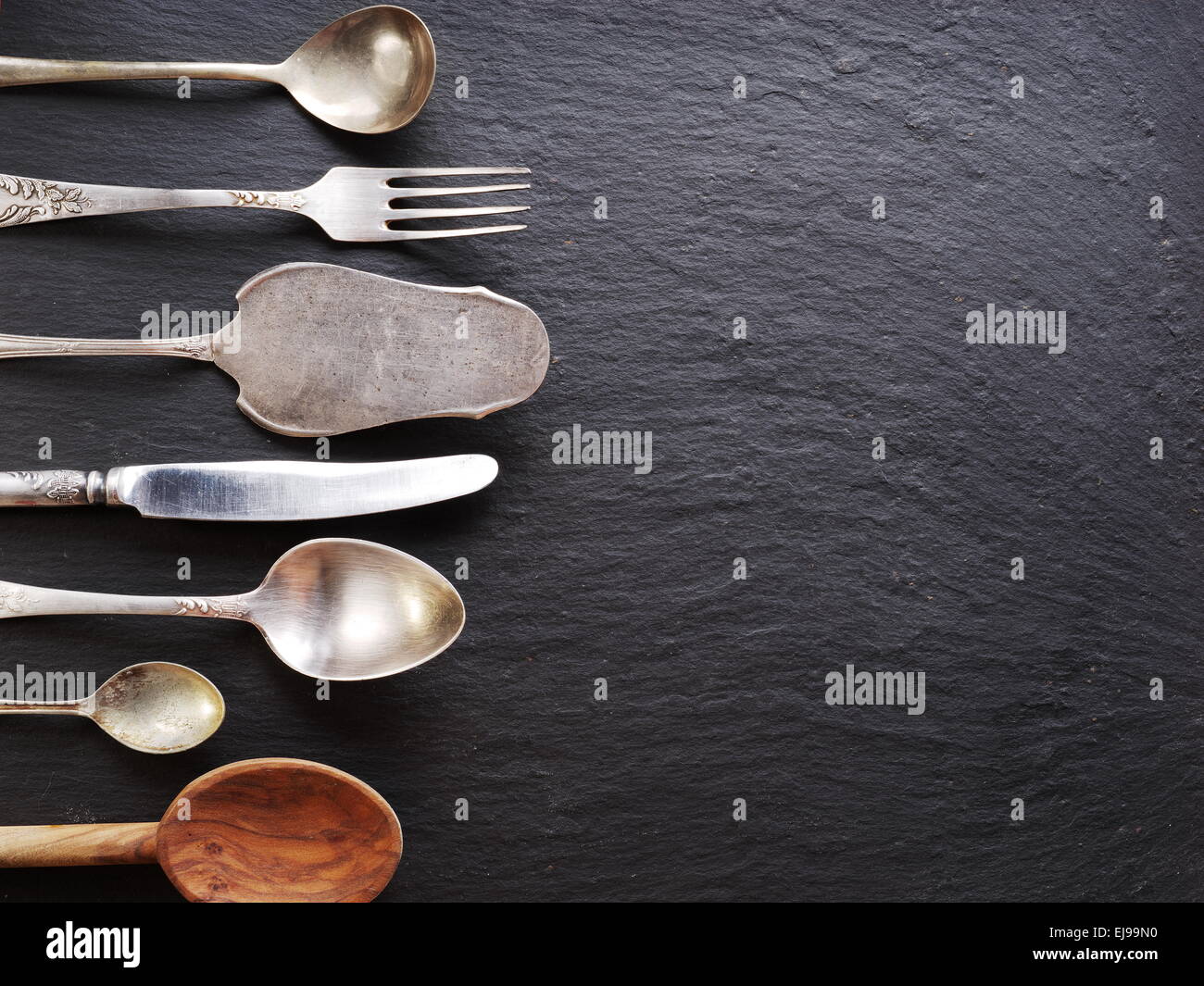 Cooking utensils on a dark gray background. Stock Photo
