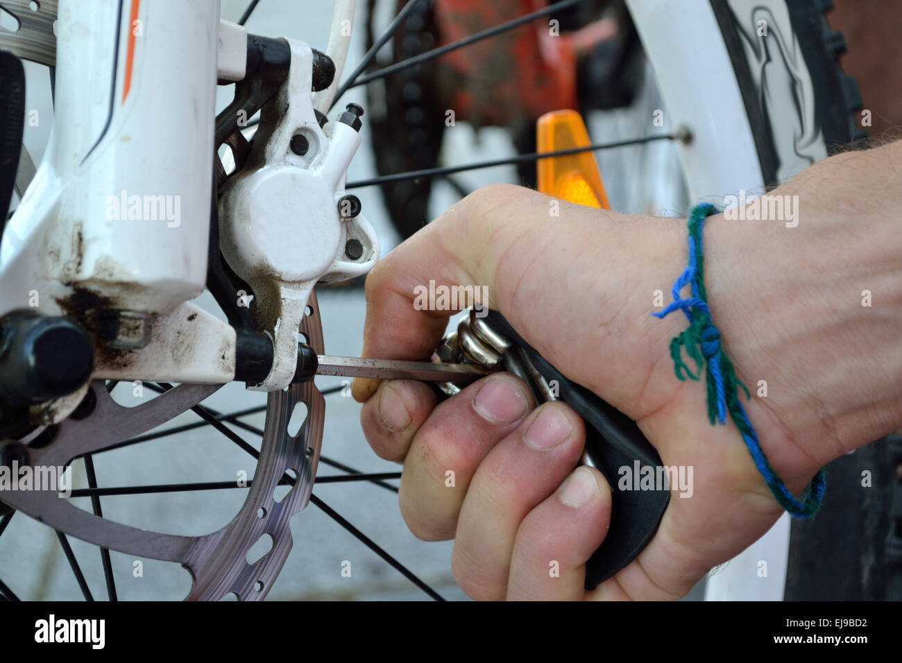 Person adjusting to a bicycle brake Stock Photo