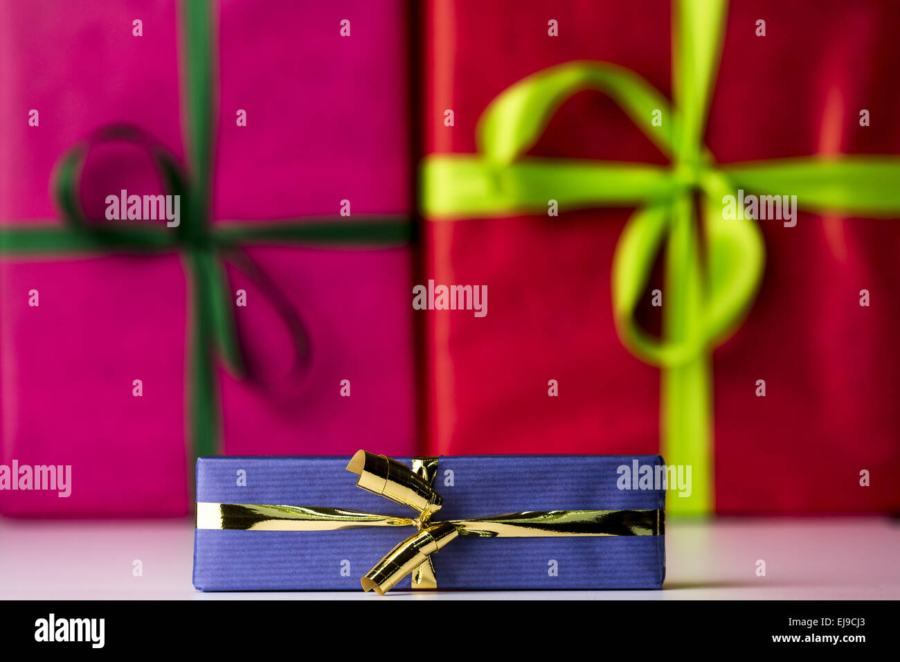 Three bowknots tied around gifts Stock Photo
