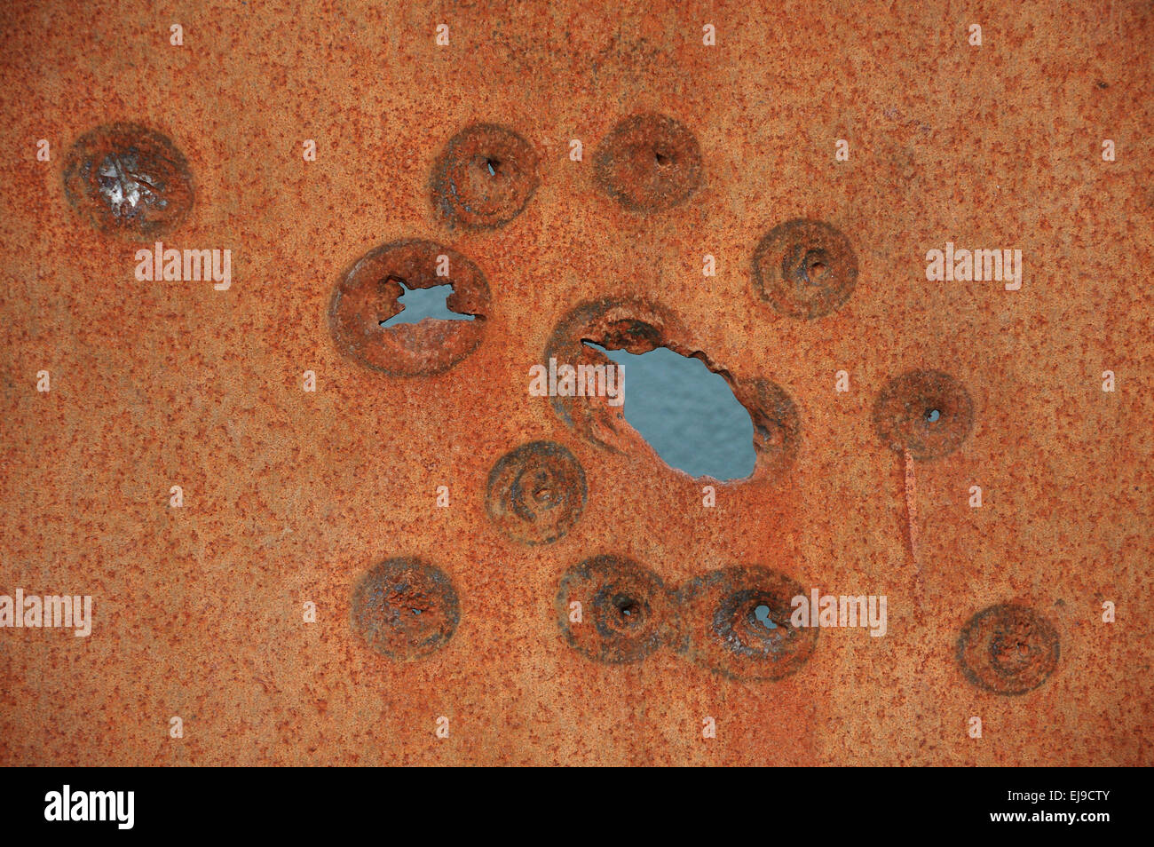 Bullet holes on a rusty plate Stock Photo