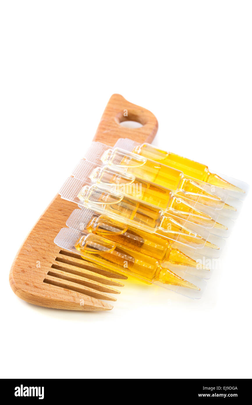Hair oil and wooden comb Stock Photo Alamy