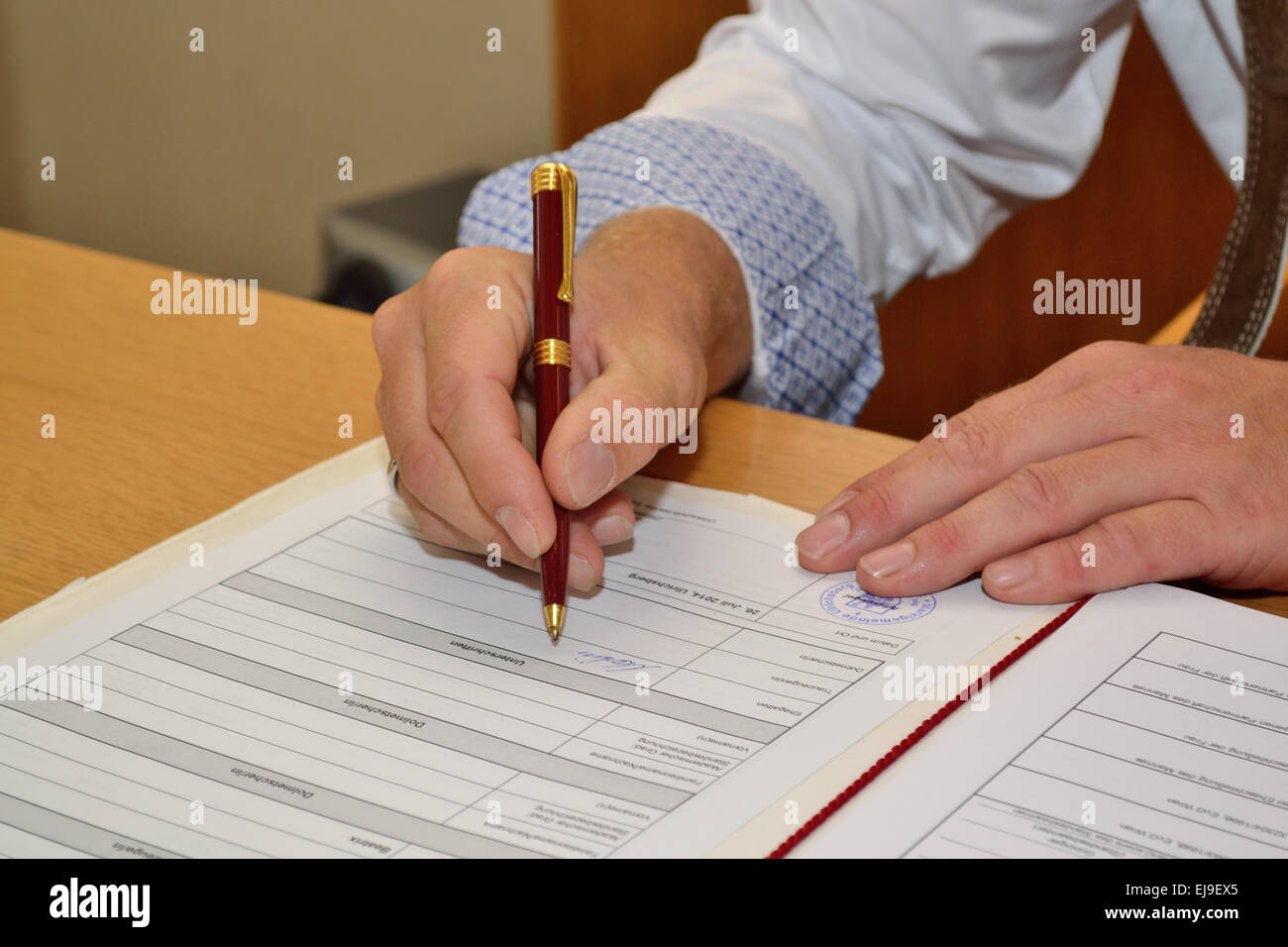 Man signing certificate Stock Photo