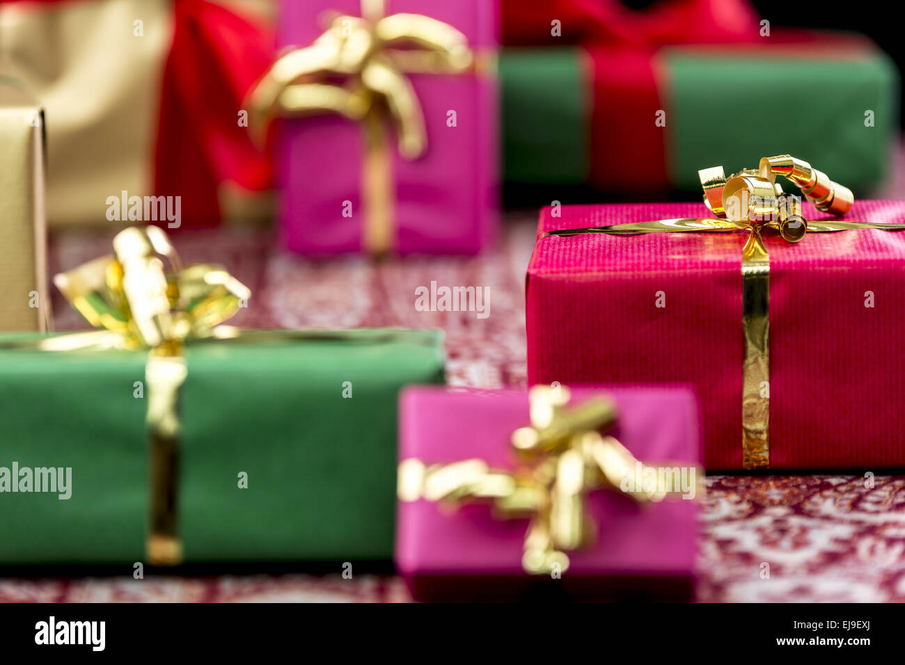 Wrapped Presents with Bows in Gold and Red Stock Photo