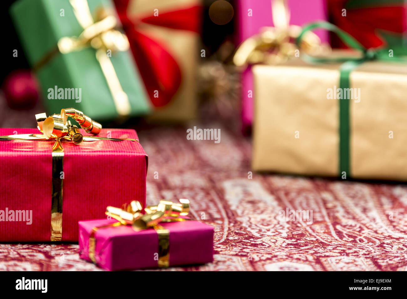 Red Present Among Other Gifts and Baubles Stock Photo