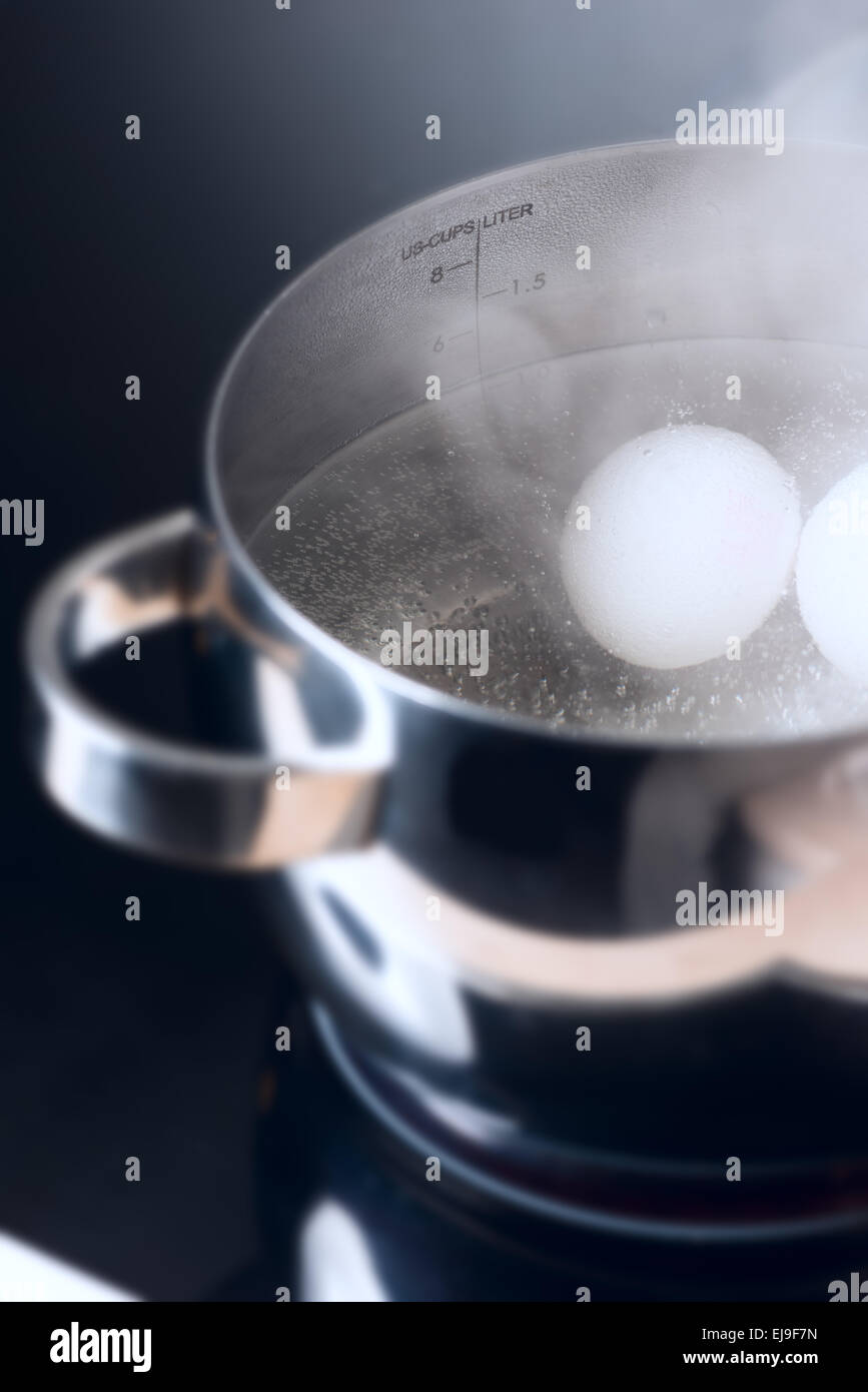 Boiling eggs on cooktop side view Stock Photo Alamy