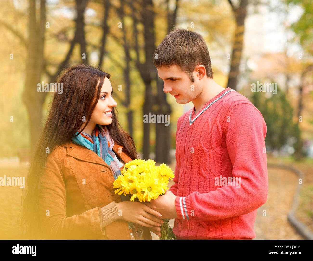 Couple enjoying golden autumn fall season Stock Photo