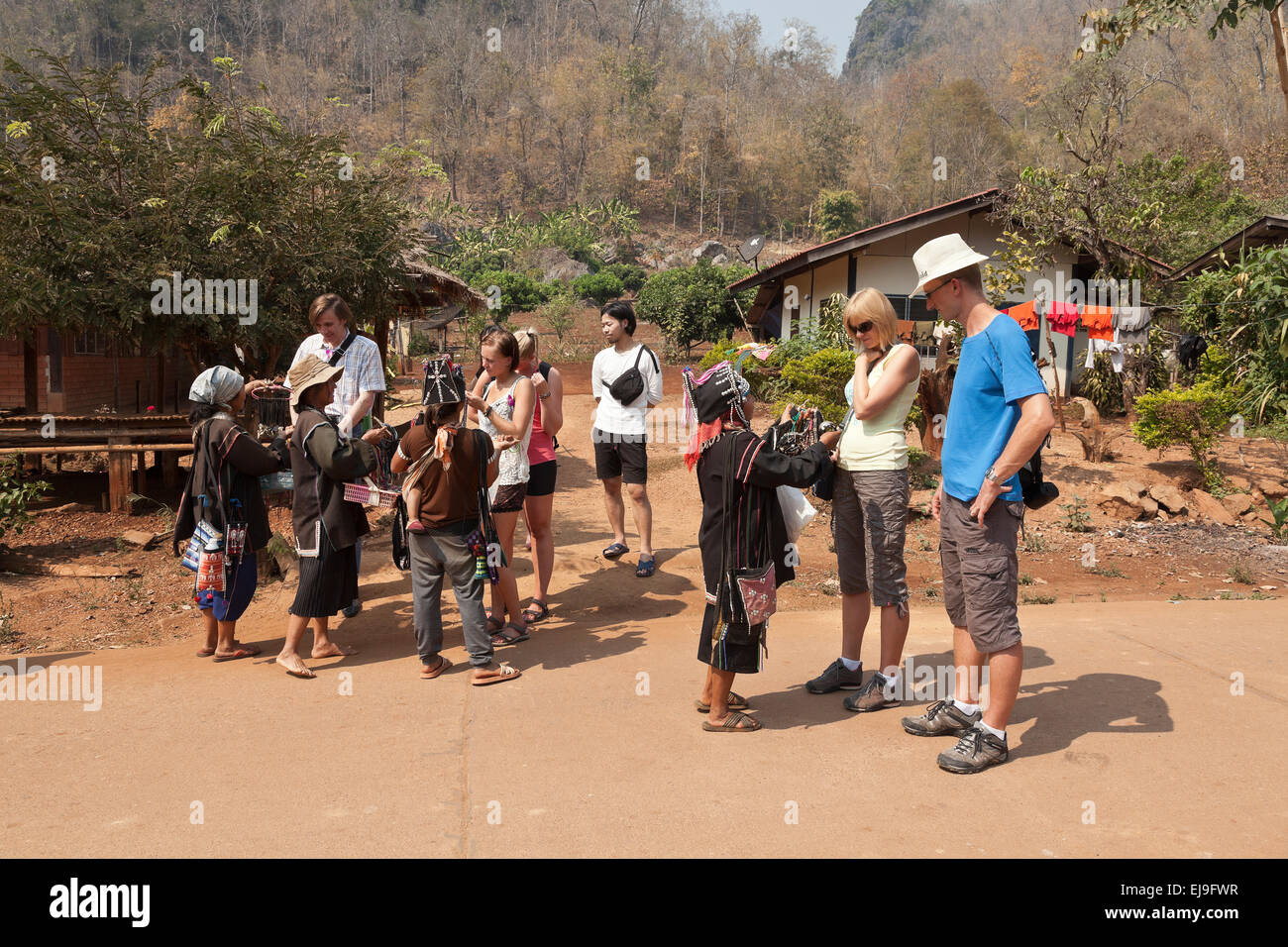 Akha women, Northern Thailand, selling craft work to visiting tourists Stock Photo