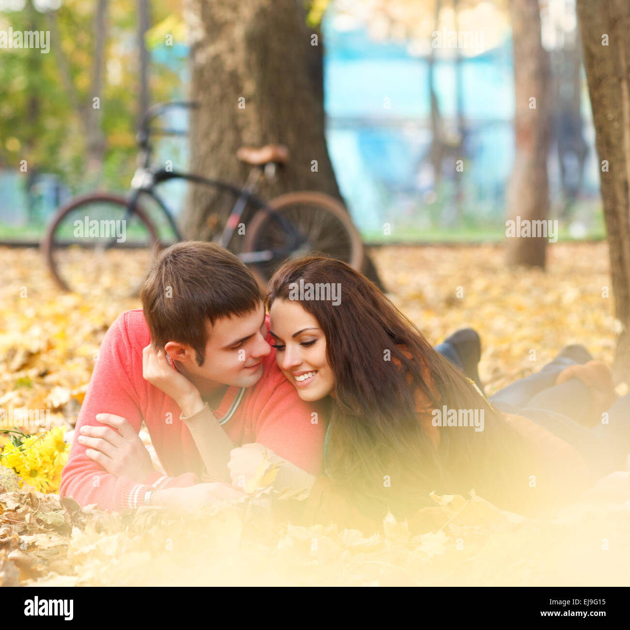 Happy young couple in autumn park Stock Photo - Alamy