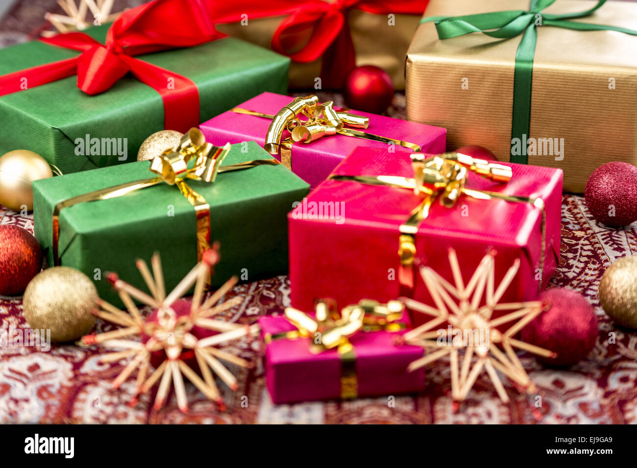 Xmas Presents with Bows, Baubles and Stars Stock Photo