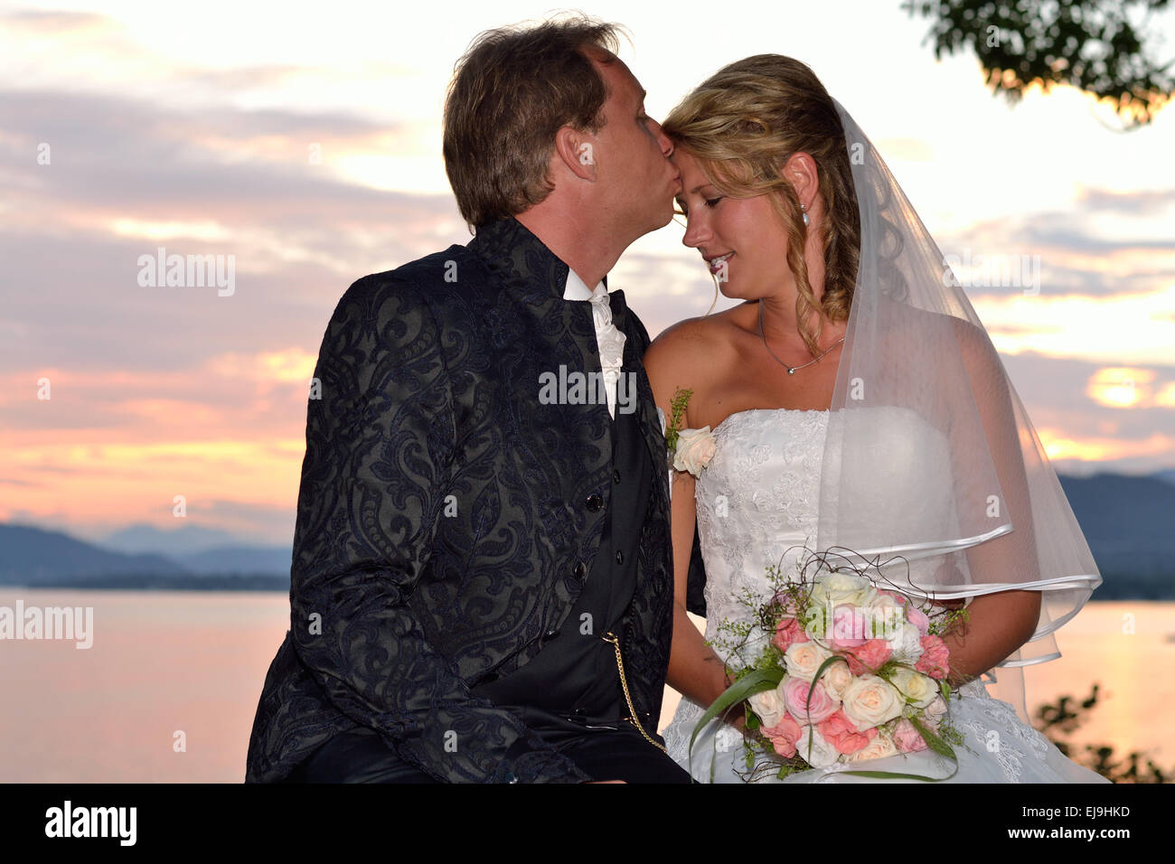 Groom kisses bride at the lake Stock Photo