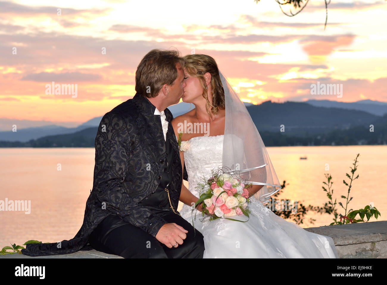 Wedding couple kissing at sunset Stock Photo